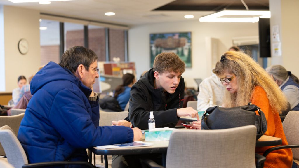 A photo of people studying around a table.