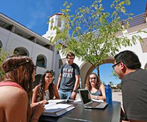 Students from SDSU study around a laptop